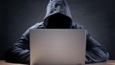 Computer hacker stealing data from a laptop concept for network security, identity theft and computer crime